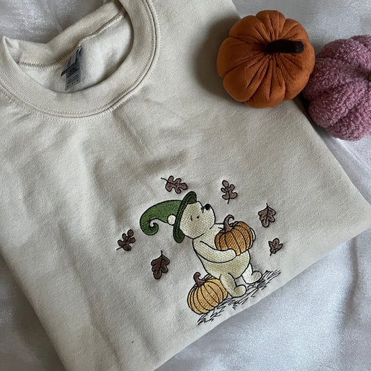 Beige sweatshirt with embroidered design of a bear with pumpkins 