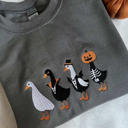 Gray sweatshirt with Halloween-themed geese design 